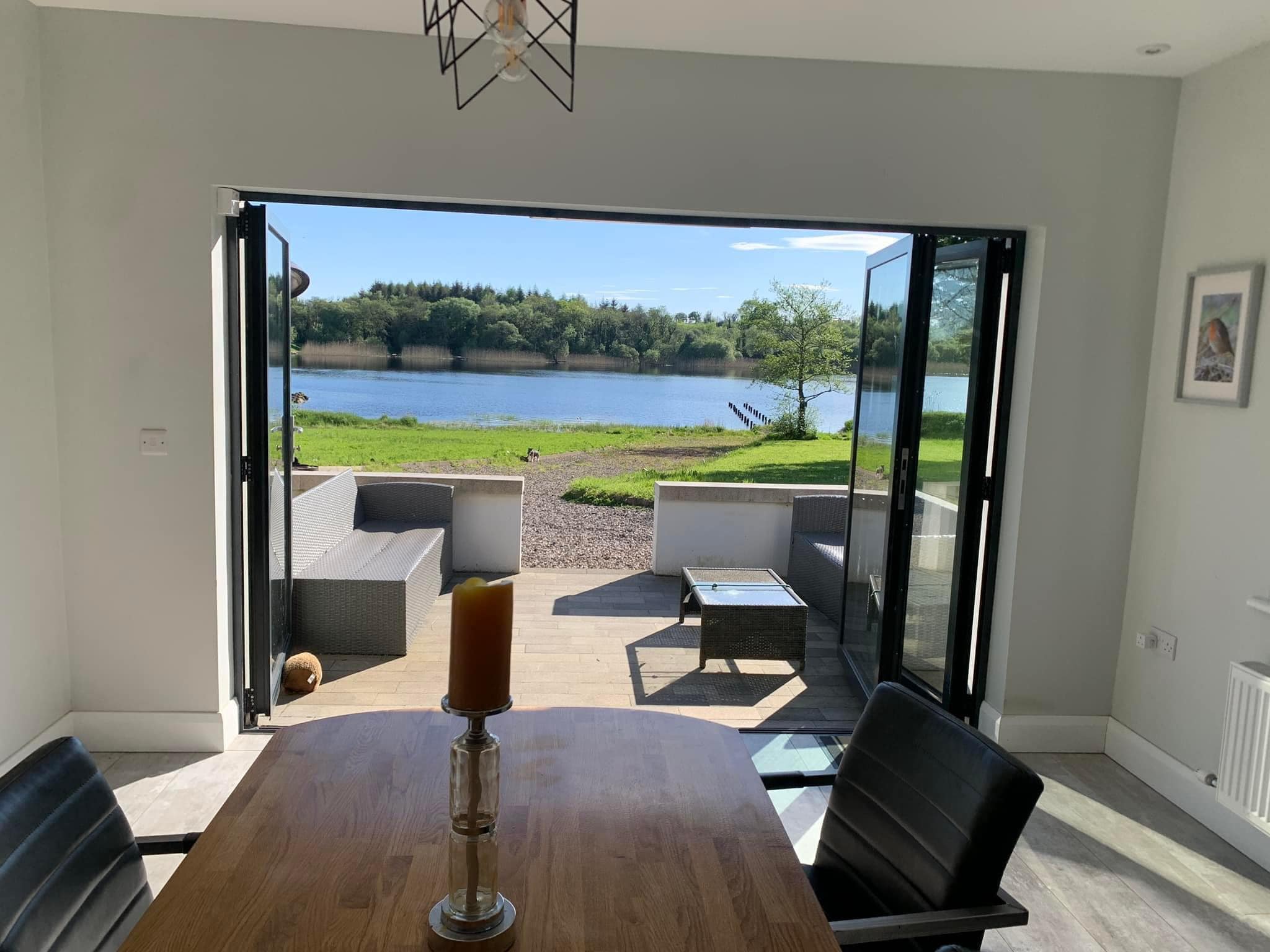 Erinona House interior with bi-fold doors opening to lake view