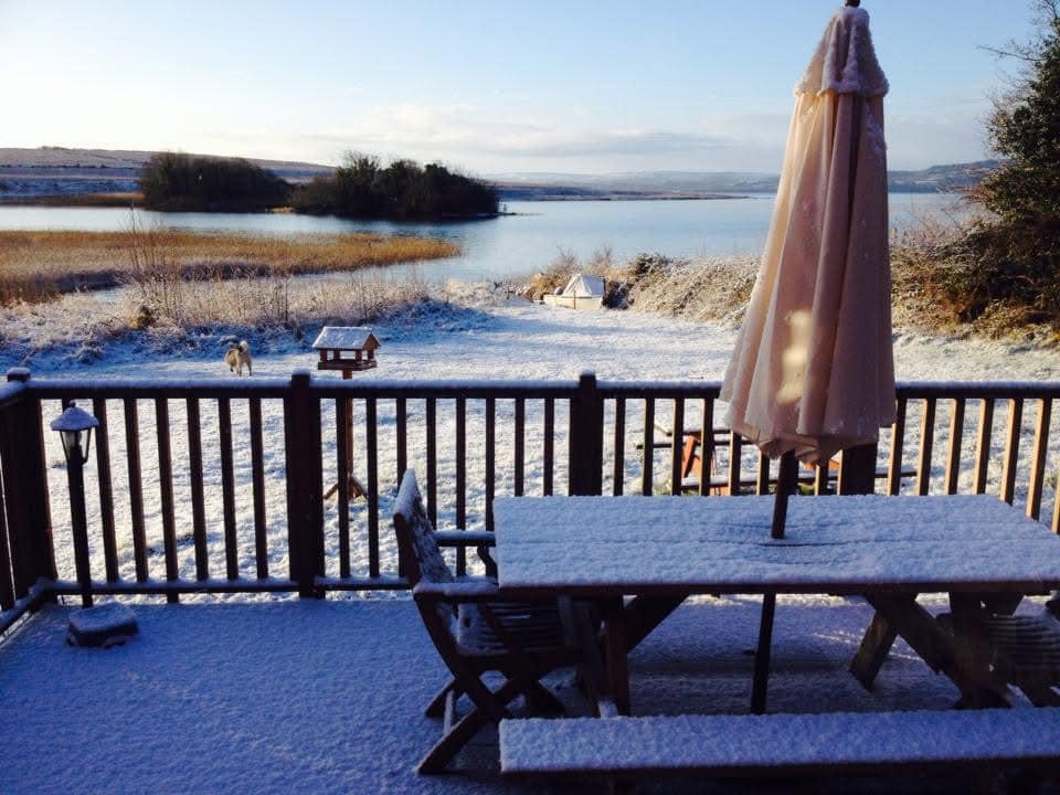 Snow-covered deck with stunning winter lake views