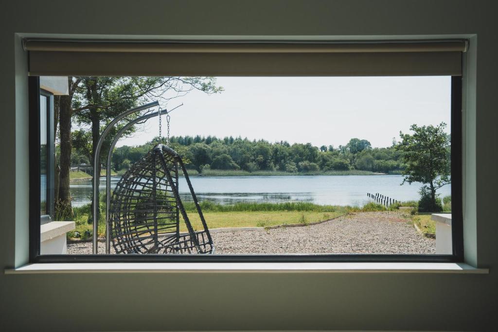 View from Erinona House window overlooking the lake with hanging egg chair